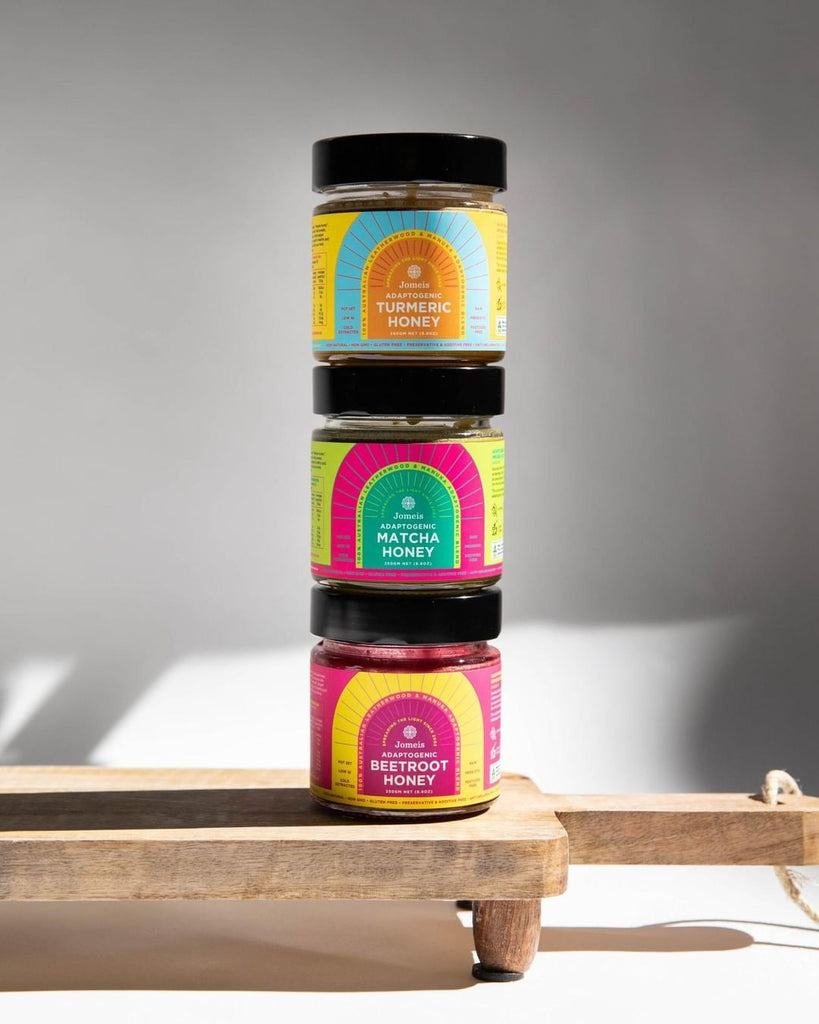A trio of Adaptogenic Honey from Jomeis Fine Foods. They are stacked on top of one another with beetroot honey on the bottom.