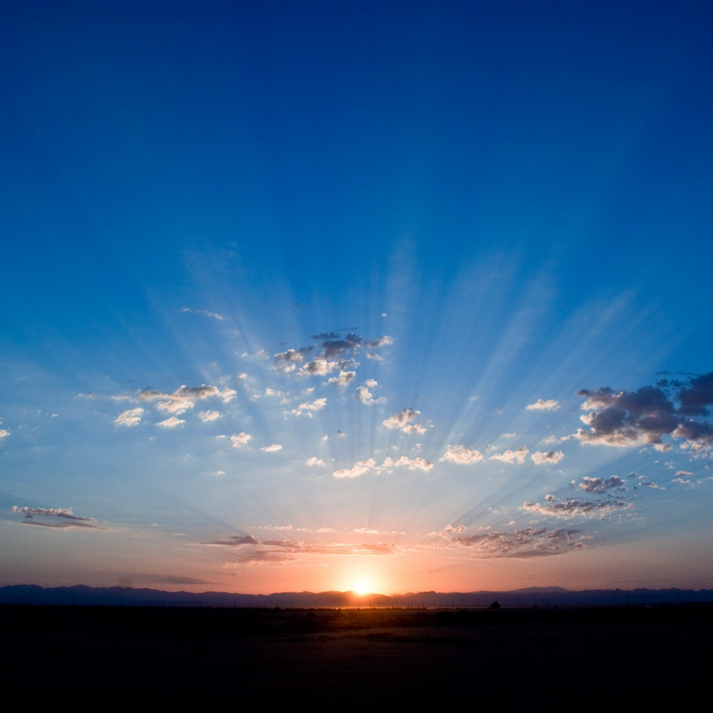 A sun rising over the horizon