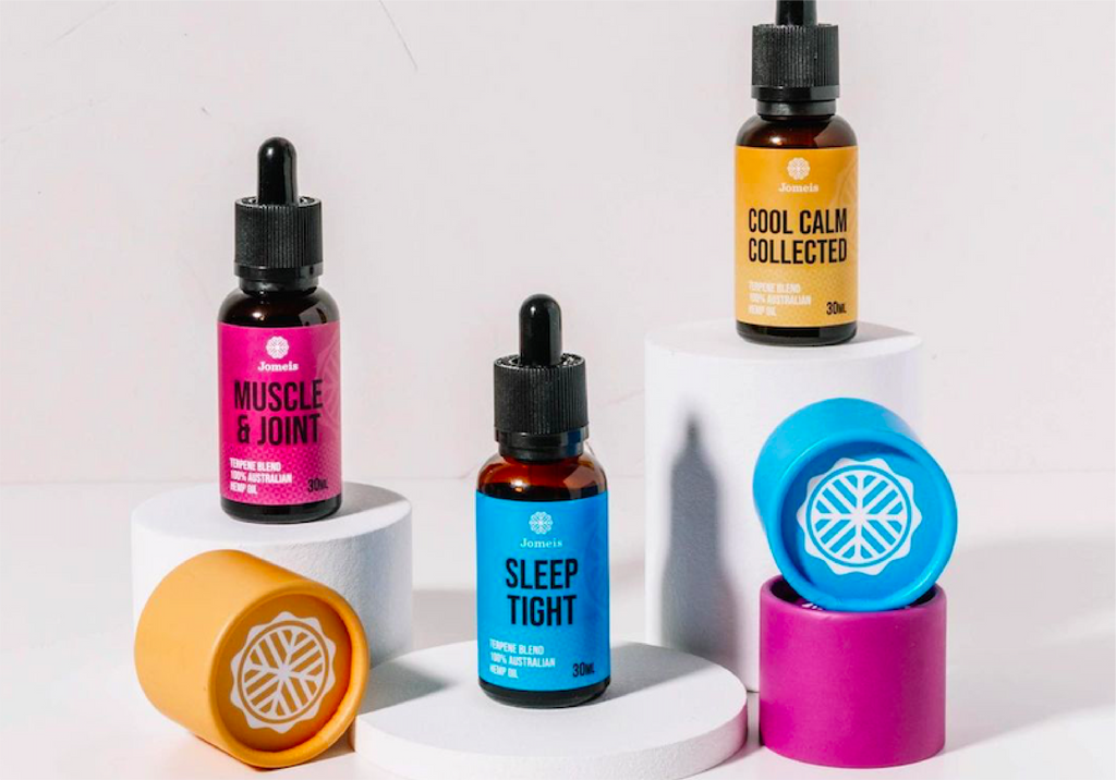 Three terpenes sitting on ledges, each a different height. The lowest one is a blue sleep tight terpene, the middle one is a pink muscle and joint terpene and the highest one is a yellow cool calm collected terpene. 