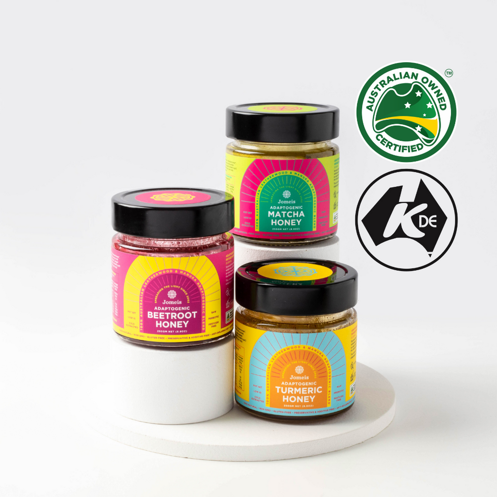 Three adaptogenic honey pots on a stand. The image features a turmeric honey, beetroot honey and matcha honey. 